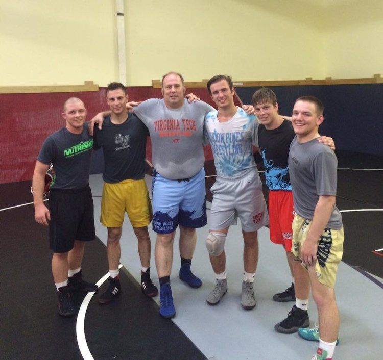 Wrestling team posing in practice room