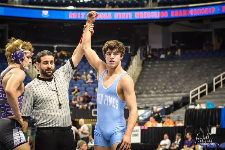 Referee declares wrestler as winner