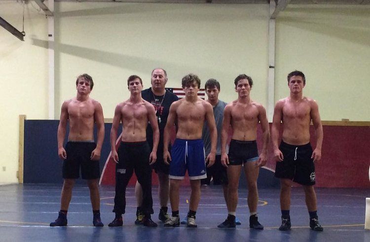 Wrestling team posing in gym
