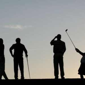 Evening golf scene with silhouettes