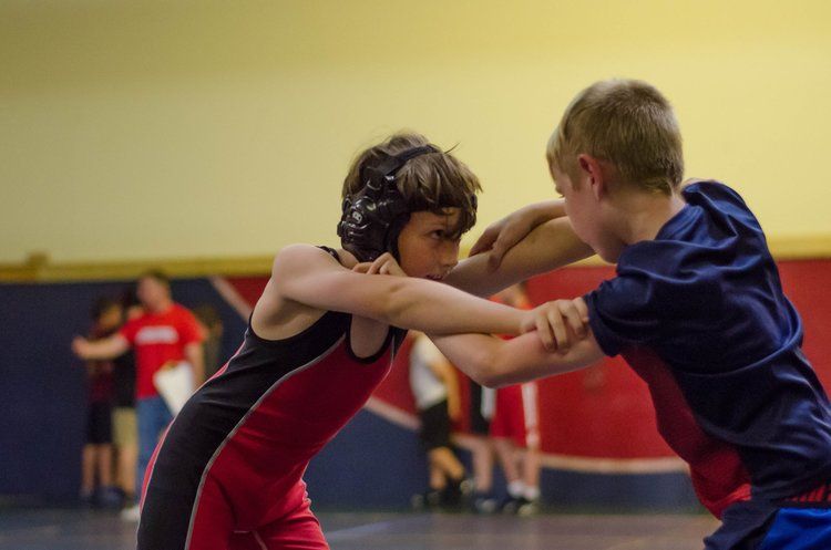 Kids grappling on wrestling mat