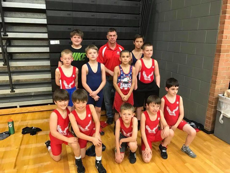 Group of young wrestlers with coach