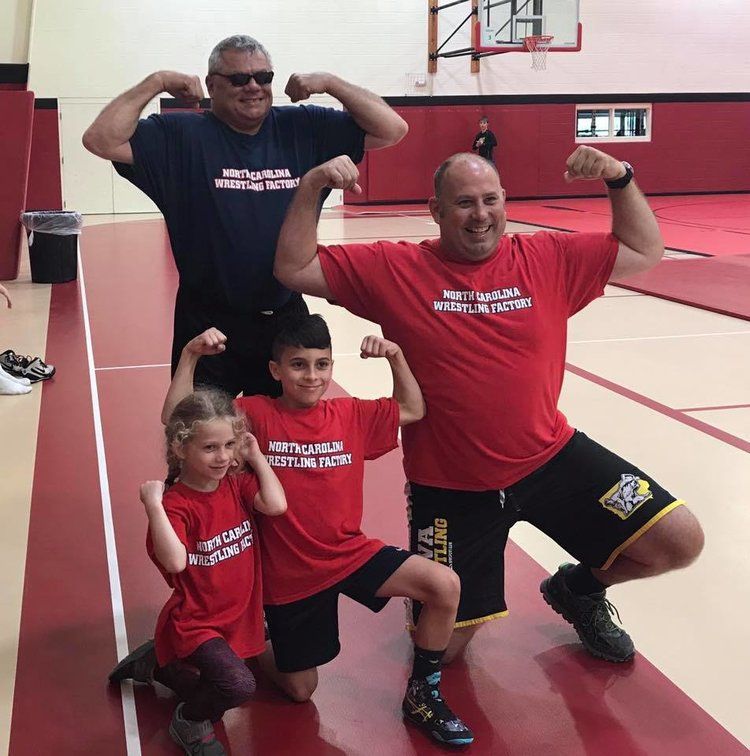 Family posing in wrestling shirts